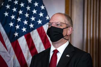 John Bel Edwards, governor of Louisiana, wears a protective mask as he participates in the mock swearing-in ceremony for Representative-elect Troy Carter, a Democrat from Louisiana, not pictured, in the Rayburn Room in the U.S. Capitol in Washington, D.C., U.S., on Tuesday, May 11, 2021. Lawmakers face an uncertain path forward on a debt limit fix, as experts offer differing projections of how soon they'll have to raise or suspend the ceiling to avoid a default on payments. Photographer: Al Drago/Bloomberg via Getty Images