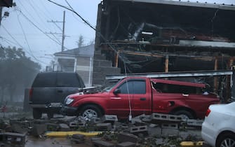 NEW ORLEANS, LOUISIANA - AUGUST 29: Vehicles are damaged after the front of a building collapsed during Hurricane Ida on August 29, 2021 in New Orleans, Louisiana. Ida made landfall earlier today southwest of New Orleans.  (Photo by Scott Olson/Getty Images)