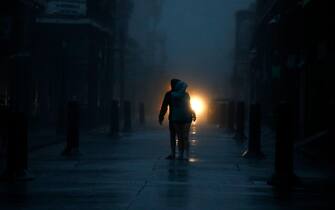 Pedestrians on Bourbon Street during a city-wide power outage caused by Hurricane Ida in New Orleans, Louisiana, U.S., on Sunday, Aug. 29, 2021. Hurricane Ida barreled into the Louisiana coast on Sunday, packing winds more powerful than Hurricane Katrina and a devastating storm surge that threatens to inundate New Orleans with mass flooding, power outages and destruction. Photographer: Luke Sharrett/Bloomberg via Getty Images