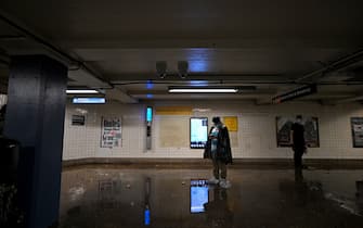 A man wearing plastic bags over his shoes waits for the subway service to resume as remnants of Hurricane Ida causes flash flooding across the city, in the New York City borough of Queens, NY, September 1, 2021. More than three inches of rain fell per hour, causing New York City subway system to be temporarily suspended. (Photo by Anthony Behar/Sipa USA)