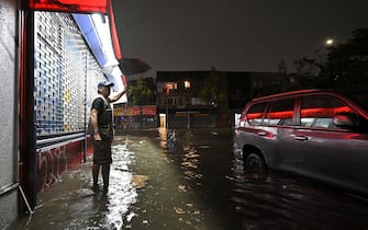 A man stands in ankle deep water caused by flash flooding brought by the remnant of hurricane Ida, in the New York City borough of Queens, NY, September 1, 2021. More than three inches of rain fell per hour, causing New York City subway system to be temporarily suspended. (Photo by Anthony Behar/Sipa USA)
