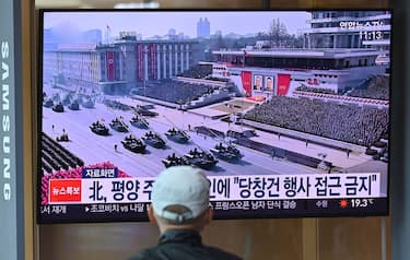 A man watches a television news broadcasting a file footage of a military parade showing North Korean soldiers and weapons, at a railway station in Seoul on October 10, 2020. - Nuclear-armed North Korea was expected to parade its latest and most advanced weapons through the streets of Pyongyang on October 10, as the coronavirus-barricaded country celebrated the 75th anniversary of leader Kim Jong Un's ruling party. (Photo by Jung Yeon-je / AFP) / The erroneous mention[s] appearing in the metadata of this photo by Jung Yeon-je has been modified in AFP systems in the following manner: changes dateline in IPTC metadata field to [Seoul] instead of [Pyongyang]. Please immediately remove the erroneous mention[s] from all your online services and delete it (them) from your servers. If you have been authorized by AFP to distribute it (them) to third parties, please ensure that the same actions are carried out by them. Failure to promptly comply with these instructions will entail liability on your part for any continued or post notification usage. Therefore we thank you very much for all your attention and prompt action. We are sorry for the inconvenience this notification may cause and remain at your disposal for any further information you may require. (Photo by JUNG YEON-JE/AFP via Getty Images)