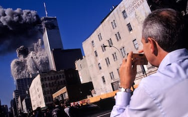 USA. New York City. September 11, 2001. An amateur photographer on Church Street captures the collapse of Tower 2, the South Tower, of the World Trade Center at 9:55 a.m. Tower 1, the North Tower, still standing here, collapsed at 10:29 a.m. Seven World Trade Center, the 47-story building seen immediately in front of Tower 1, collapsed at 5:25 p.m. 