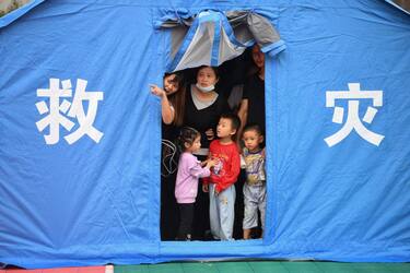 Residents look out from a tent set up for people displaced by a 5.4 earthquake that killed three and injured a dozen in Luzhou, in China's southwestern Sichuan province on September 16, 2021. - China OUT (Photo by STR / AFP) / China OUT (Photo by STR/AFP via Getty Images)