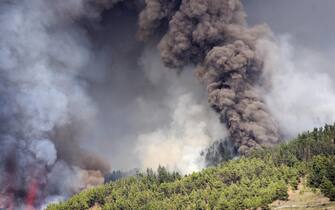 epa09476870 Smoke rises from the volcanic eruption in El Paso, La Palma, Canary islands, Spain, 19 September 2021. The area registered hundreds of small earthquakes along the week as magma pressed the subsoil on its way out. Regional authorities started to evacuate locals with mobility issues hours before the eruption took place.  EPA/Miguel Calero