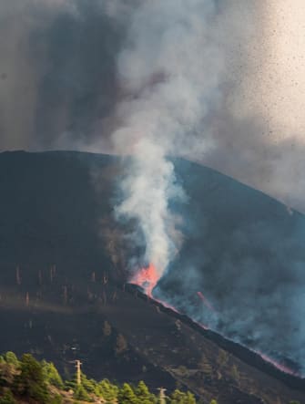 epa09486201 A view of two new eruptive mouths on the Cumbre Vieja volcano in El Paso, La Palma, Canary Islands, Spain, 24 September 2021. People from Tajuya, Tacande de Arriba and Tacande de Abajo in La Palma have been evacuated due to the new activity of the volcano. The new volcano began to erupt in Rajada Mountain in the municipality of El Paso on 19 September. The area had registered hundreds of small earthquakes along the week as magma pressed the subsoil on its way out, urging the regional authorities to evacuate locals before the eruption took place.  EPA/Miguel Calero