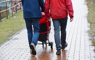 Homosexual couple which lives in a same-sex partnership walks through a park on a family daily trip with a buggy in Berlin, Germany, 11 April 2013. Photo: Jens Kalaene - MODEL RELEASED | usage worldwide   (Photo by Jens Kalaene/picture alliance via Getty Images)