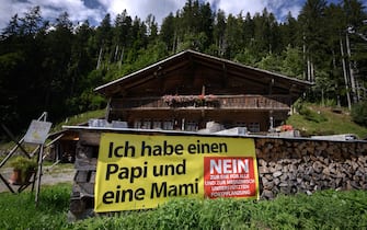 A picture taken on September 12, 2021 in the Swiss village of Jaun shows an electoral banner against the marriage for all reading in German: "I have a Daddy and Mummy" ahead of a nationwide votation. - While apartment-hunting with his partner 30 years ago, Thierry Delessert was repeatedly asked whether they were cousins, or gay. He knew the latter answer would automatically see their application thrown out. The 56-year-old historian still recalls his run-ins with "suspicious" real estate agents in Switzerland, where police in some places were still keeping registers of homosexuals. Three decades later, in a referendum on September 26, 2021, the wealthy Alpine nation looks set to allow same-sex couples to marry, and grant them the same rights as their heterosexual counterparts. (Photo by Fabrice COFFRINI / AFP) (Photo by FABRICE COFFRINI/AFP via Getty Images)