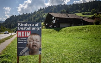 An electoral poster showing a baby crying and reading in German: "Children on demand? No to sperm donation and marriage for all" is seen ahead of a nationwide votation on the marriage for all in Zweisimmen, Berner Oberland, on September 12, 2021. - While apartment-hunting with his partner 30 years ago, Thierry Delessert was repeatedly asked whether they were cousins, or gay. He knew the latter answer would automatically see their application thrown out. The 56-year-old historian still recalls his run-ins with "suspicious" real estate agents in Switzerland, where police in some places were still keeping registers of homosexuals. Three decades later, in a referendum on September 26, 2021, the wealthy Alpine nation looks set to allow same-sex couples to marry, and grant them the same rights as their heterosexual counterparts. (Photo by Fabrice COFFRINI / AFP) (Photo by FABRICE COFFRINI/AFP via Getty Images)