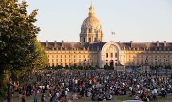 People sit and enjoy the sun and picnic on the garden of the Esplanade des Invalides in Paris on May 30, 2020, on the first day of reopening following the nationwide lockdown put into place on March 17, to stop the spread of the novel corona virus COVID-19 pandemic. Photo by Raphael Lafargue/ABACAPRESS.COM