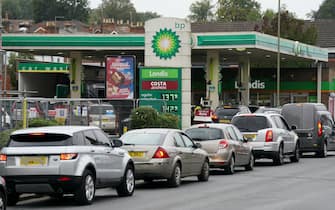 1235601035 Vehicles queue up outside a BP petrol station in Alton, Hampshire. Picture date: Thursday September 30, 2021. (Photo by Andrew Matthews/PA Images via Getty Images)