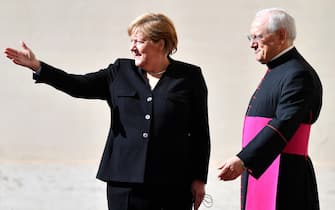 German Chancellor Angela Merkel (L) is welcomed by Italian priest and writer Monsignor Leonardo Sapienza (R) as she arrives for a private audience with Pope Francis, at San Damaso courtyard in Vatican City, 07 October 2021.   ANSA/ETTORE FERRARI
 