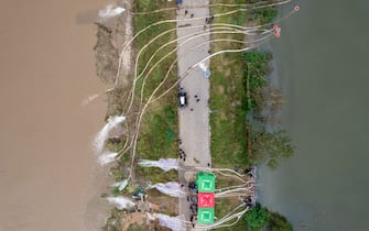 JINZHONG, CHINA - OCTOBER 10: Aerial view of rescue teams pumping water at flooded Jiexiu Fenhe wetland park on October 10, 2021 in Jinzhong, Shanxi Province of China. Heavy rains have caused floods and disasters in Shanxi Province. (Photo by Wei Liang/China News Service via Getty Images)