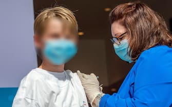 Charles Muro,age 13, is inoculated by Nurse Karen Pagliaro at Hartford  Healthcares mass vaccination center at the Connecticut Convention Center in Hartford, Connecticut on May 13, 2021. - Six Children were vaccinated at the site and joined other children in the United States as kids ages 12-15 are now able to be vaccinated with the Pfizer-BioNTech Covid-19 vaccine, joining the growing population of the US that can be vaccinated against the Covid-19 virus. (Photo by Joseph Prezioso / AFP) (Photo by JOSEPH PREZIOSO/AFP via Getty Images)