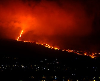SANTA CRUZ DE LA PALMA, SPAIN - OCTOBER 12: Lava flows from Cumbre Vieja during an eruption on October 12, 2021 in Santa Cruz de la Palma, La Palma, Canary Islands, Spain. Since last Saturday's collapse of the north face of the Cumbre Vieja volcanic cone on La Palma, the volcano's effusive and eruptive activity has increased, and this increased lava flow and the great fluidity of the lava flows have raised the affected area to 595 hectares. According to the report published Tuesday by the Department of Homeland Security (DSN) of the Government, the most active lava flow is currently the one located farthest north. (Photo By Alexandre Diaz/Europa Press via Getty Images)