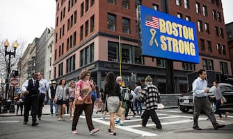 BOSTON, MA - APRIL 14:  People walk past an electronic billboard reading "Boston Strong" near the finish line of the Boston Marathon, on April 14, 2014 in Boston, Massachusetts. Last year, two pressure cooker bombs killed three and injured an estimated 264 others during the Boston marathon, on April 15, 2013.  (Photo by Andrew Burton/Getty Images)