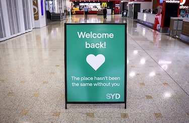 A sign is displayed inside the empty arrivals hall at the international airport in Sydney on October 15, 2021. (Photo by DAVID GRAY / AFP) (Photo by DAVID GRAY/AFP via Getty Images)