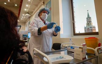 epa09557792 A nurse prepares to administer a woman with a shot of Russia's Sputnik V COVID-19 vaccine at a vaccination point at the State Department Store GUM, in Moscow, Russia, 01 November 2021. Authorities approved non-working week from 28 October to 07 November in Russia to curb the fast spreading of coronavirus disease (COVID-19) infections. Restrictions are also put in place during the non-working week, such as the closure of shopping malls, beauty salons, fitness centers and car services. However, pharmacies, hospitals, food stores, museums and theaters will stay open. Cafes and restaurants will only open for takeout and delivery orders.  EPA/YURI KOCHETKOV