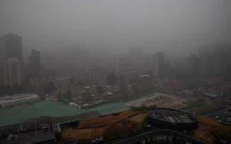epa09565346 City buildings are seen during a polluted day in Beijing, China, 05 November 2021. China, the world's largest polluter, has promised to the UN to bring its emissions to a peak before 2030 and cut them to net-zero by 2060. From 31 October until 12 November 2021 most of the countries and their leaders are focused on the COP26 climate change conference in Glasgow, the most important climate change event.  EPA/ROMAN PILIPEY