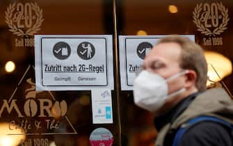 epa09563834 An information sign with letters 'Access according to 2G rule, vaccinated recovered' is placed on a window at a cafe in the old town of Heidelberg, Germany, 04 November 2021. Due to an increasing number of cases of the pandemic COVID-19 disease caused by the coronavirus SARS CoV-2, new nationwide restrictions have been announced to counter a surge in infections.  EPA/RONALD WITTEK
