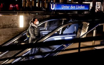 epa09566462 A pedestrian walks out from underground station in central Berlin, Germany, 05 November 2021. Due to an increasing number of cases of the pandemic COVID-19 disease caused by the corona virus SARS CoV-2, new nationwide restrictions have been announced to counter a surge in infections.  EPA/FILIP SINGER