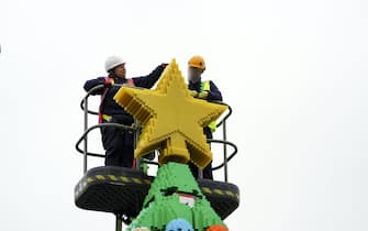 Model makers put the finishing touches to a 33-foot tall LEGO Christmas tree, made with 364,481 DUPLO and LEGO bricks, at the LEGOLAND Windsor Resort in Berkshire.  Picture date: Wednesday November 10, 2021.