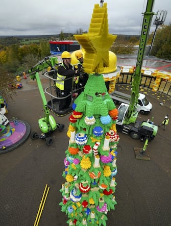 Model makers put the finishing touches to a 33-foot tall LEGO Christmas tree, made with 364,481 DUPLO and LEGO bricks, at the LEGOLAND Windsor Resort in Berkshire. Picture date: Wednesday November 10, 2021.