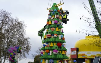 A model maker puts the finishing touches to a 33-foot tall LEGO Christmas tree, made with 364,481 DUPLO and LEGO bricks, at the LEGOLAND Windsor Resort in Berkshire. Picture date: Wednesday November 10, 2021.
