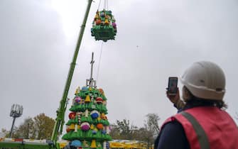 A crane hoists a section of a 33-foot tall LEGO Christmas tree made with 364,481 DUPLO and LEGO bricks, at the LEGOLAND Windsor Resort in Berkshire.  Picture date: Wednesday November 10, 2021.