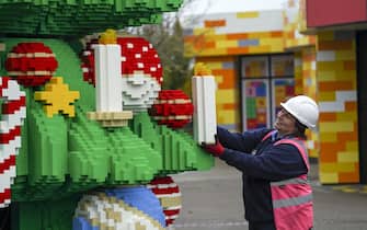 Chief Model Maker Paula Laughton puts the finishing touches to a 33-foot tall LEGO Christmas tree, made with 364,481 DUPLO and LEGO bricks, at the LEGOLAND Windsor Resort in Berkshire. Picture date: Wednesday November 10, 2021.