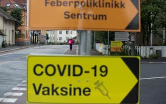A sign for a Covid-19 vaccine center in Oslo, Norway, on Monday, Aug. 2, 2021. Norway is the new No. 1 in Bloomberg's Covid Resilience Ranking, with enough shots administered to cover almost half its population, few new fatalities and its borders unsealed. Photographer: Fredrik Solstad/Bloomberg
