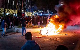 NETHERLANDS CORONAVIRUS PROTEST epa09592757 A scooter set on fire during a protest against the 2G policy in Coolsingel, Rotterdam, Netherlands, 19 November 2021. Hundreds of demonstrators have gathered to protest against the tightened coronavirus measures. EPA/Killian Lindenburg