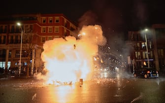 THE HAGUE, NETHERLANDS - NOVEMBER 20: Fireworks explode in a fire of bycicle and scooters as riots erupt amid new Corona virus restrictions on November 20, 2021 in The Hague, Netherlands. (Photo by Pierre Crom/Getty Images)