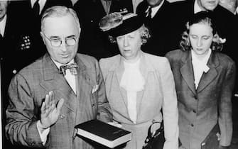 Harry S. Truman (1884 - 1972) takes the oath at the start of his term of office as the 33rd president of the United States. Standing beside him are his wife Bess and daughter Margaret.   (Photo by Central Press/Getty Images)