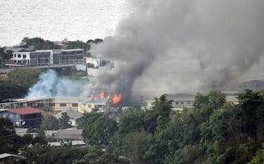 Smoke from fires rise from buildings in Honiara on the Solomon Islands on November 25, 2021, on the second day of rioting that left the capital ablaze and threatened to topple the Pacific nation's government. (Photo by CHARLEY PIRINGI / AFP) (Photo by CHARLEY PIRINGI/AFP via Getty Images)