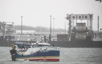 epa09605026 French fishing boats block the entrance of the Port of Calais starting a day of protests to mark anger over the issue of post-Brexit fishing licences, in Calais, France, 26 November 2021.  EPA/MOHAMMED BADRA