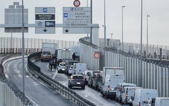 TOPSHOT - Vehicles queues at the entrance of the port of Calais on November 26, 2021. - French fishing boats block the port entrance cross-Channel traffic in protest at the post-Brexit fishing rights granted by Britain, blocking ferries seeking to access the northern port of Calais.  (Photo by FRANCOIS LO PRESTI / AFP) (Photo by FRANCOIS LO PRESTI / AFP via Getty Images)