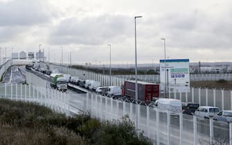 Vehicles queues at the entrance of the port of Calais on November 26, 2021. - French fishing boats block the port entrance cross-Channel traffic in protest at the post-Brexit fishing rights granted by Britain, blocking ferries seeking to access the northern port of Calais. (Photo by FRANCOIS LO PRESTI / AFP) (Photo by FRANCOIS LO PRESTI/AFP via Getty Images)