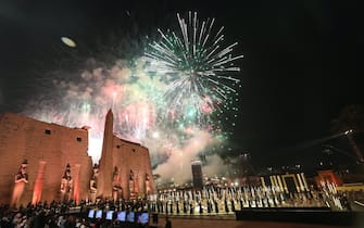 epa09603413 Fireworks illuminate the sky during the opening ceremony of the Avenue of Sphinxes at the ancient Temple of Luxor, in Luxor, Egypt, 25 November 2021. The 3,000-year-old ancient promenade Avenue of Sphinxes (El Kebbash Road) was opened to the public after years of restauration with a grand ceremony.  EPA / KHALED ELFIQI