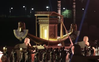 epa09603501 Actors carry a golden boat as they parade during the opening ceremony of the Avenue of Sphinxes at the ancient Temple of Luxor, in Luxor, Egypt, 25 November 2021. The 3,000-year-old ancient promenade Avenue of Sphinxes (El Kebbash Road) was opened to the public after years of restauration with a grand ceremony.  EPA/KHALED ELFIQI