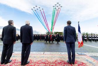 A handout photo made available by Quirinale Palace shows Italian President Sergio Mattarella (C), French President Emmanuel Macron (R) and Italian Prime Minister Mario Draghi look on Italian Air Force (Aeronautica Militare)'s aerobatic demonstration team, the Frecce Tricolori (lit.Tricolour Arrows) and the 'Patrouille de France' aerobatics team, flying over the Quirinal Palace on the occasion of the signing of the Quirinal Treaty between Italy and France in Rome, Italy, 26 November 2021. ANSA/ PAOLO GIANDOTTI - QUIRINALE PRESS OFFICE ++HO - NO SALES EDITORIAL USE ONLY++