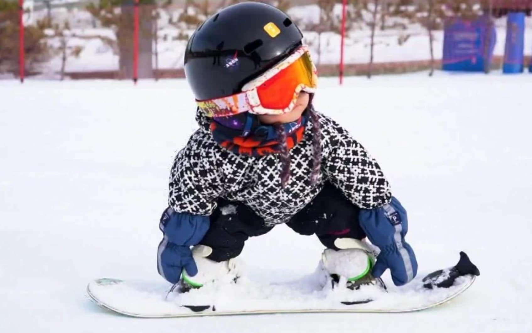 China, 11-month-old baby goes snowboarding in the snow and becomes a web star.  VIDEO