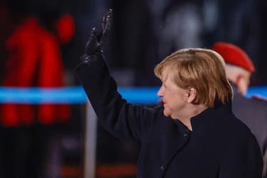 German Chancellor Angela Merkel waves goodbye at the Defence Ministry during the Grand Tattoo (Grosser Zapfenstreich), a ceremonial send-off for her in Berlin on December 2, 2021. - - ALTERNATIVE CROP (Photo by Odd ANDERSEN / POOL / AFP) / ALTERNATIVE CROP (Photo by ODD ANDERSEN/POOL/AFP via Getty Images)