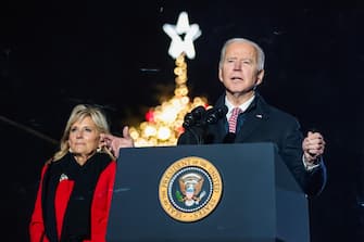 epa09617812 First Lady Dr. Jill Biden (L) joins President Joe Biden (R) on stage as he delivers remarks during a National Christmas tree lighting ceremony held at The Ellipse outside The White House in Washington, DC, USA,  02 December 2021.  EPA/OLIVER CONTRERAS / POOL