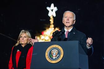 epa09617812 First Lady Dr. Jill Biden (L) joins President Joe Biden (R) on stage as he delivers remarks during a National Christmas tree lighting ceremony held at The Ellipse outside The White House in Washington, DC, USA,  02 December 2021.  EPA/OLIVER CONTRERAS / POOL