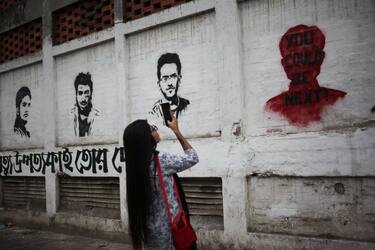 A girl seen taking picture of a wall painting made by University students in Dhaka University in Dhaka, Bangladesh on 25 October 2019, after student Abrar Fahad was allegedly beaten to death by ruling party activists on October 07. (Photo by Syed Mahamudur Rahman/NurPhoto via Getty Images)
