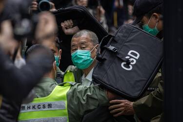epa09623471 Media mogul Jimmy Lai (C) is escorted out of a Correctional Services Department vehicle and into the Court of Final Appeal in Hong Kong, China, 09 February 2021. Lai returned to court and has applied for bail after being accused of colluding with foreign forces under the national security law.  EPA/JEROME FAVRE