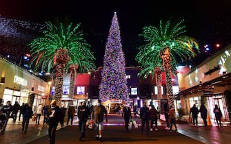 A 115-foot Christmas tree lights up the Citadel Outlets on December 9, 2021 in Los Angeles, California as people shop ahead of the holidays. - The Labor Department on December 10 will present its November report on consumer prices, which analysts expect will show inflation accelerated from the 30-year high hit in the 12-months ended in October. (Photo by Frederic J. BROWN / AFP) (Photo by FREDERIC J. BROWN/AFP via Getty Images)