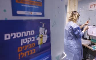 A healthcare prepares a Pfizer-BioNTech Covid-19 vaccine for a child at the Meuhedet mobile medical center in Tel Aviv, Israel, on Tuesday, Nov. 23, 2021. Israel began innoculating children aged 5-11 with the Pfizer-BioNTech vaccine. Photographer: Kobi Wolf/Bloomberg