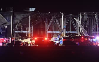 EDWARDSVILLE, IL - DECEMBER 10: First responders surround a damaged Amazon Distribution Center on December 10, 2021 in Edwardsville, Illinois. According to reports, the Distribution Center was struck by a tornado Friday night. Emergency vehicles arrived to start rescue operations for workers believed to be trapped inside. (Photo by Michael B. Thomas/Getty Images)